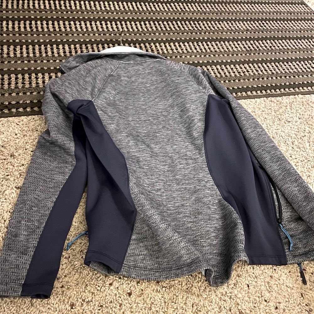 The North Face blue and grey zip up sweatshirt. Size small, great condition!